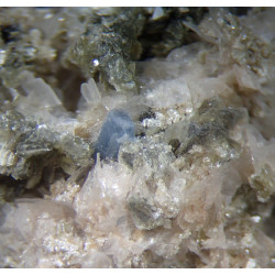 A 2 mm fluorapatite crystal with bladed bertrandite