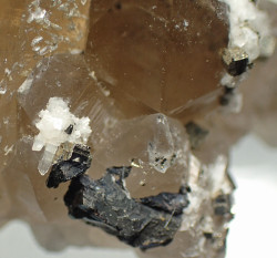 White bertrandite and sphalerite on smoky quartz